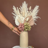 High Objects Altura Earthtone Clay Vase, a tall, matte beige ceramic vase with dried eucalyptus and pampas grass.