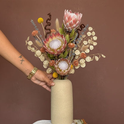 High Objects Altura Earthtone Clay Vase, a tall matte clay vase with dried eucalyptus and pampas grass.