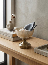 High Objects textured amber glass bowl with a brass pedestal base, perfect for decorative use.
