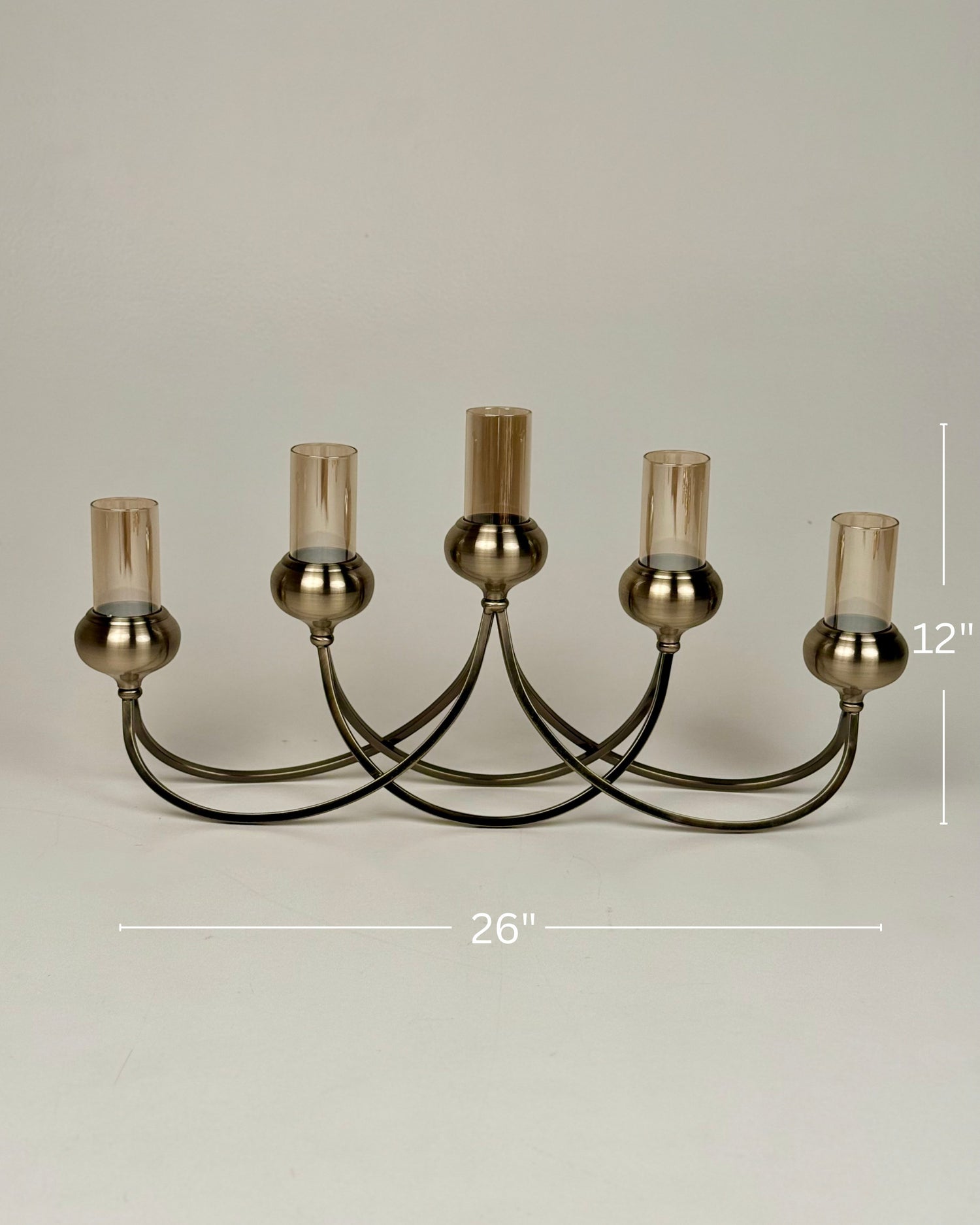 High Objects Aria Five-Arm Candle Stand with tinted glass holders and antique brass finish. 26" W x 12" H.