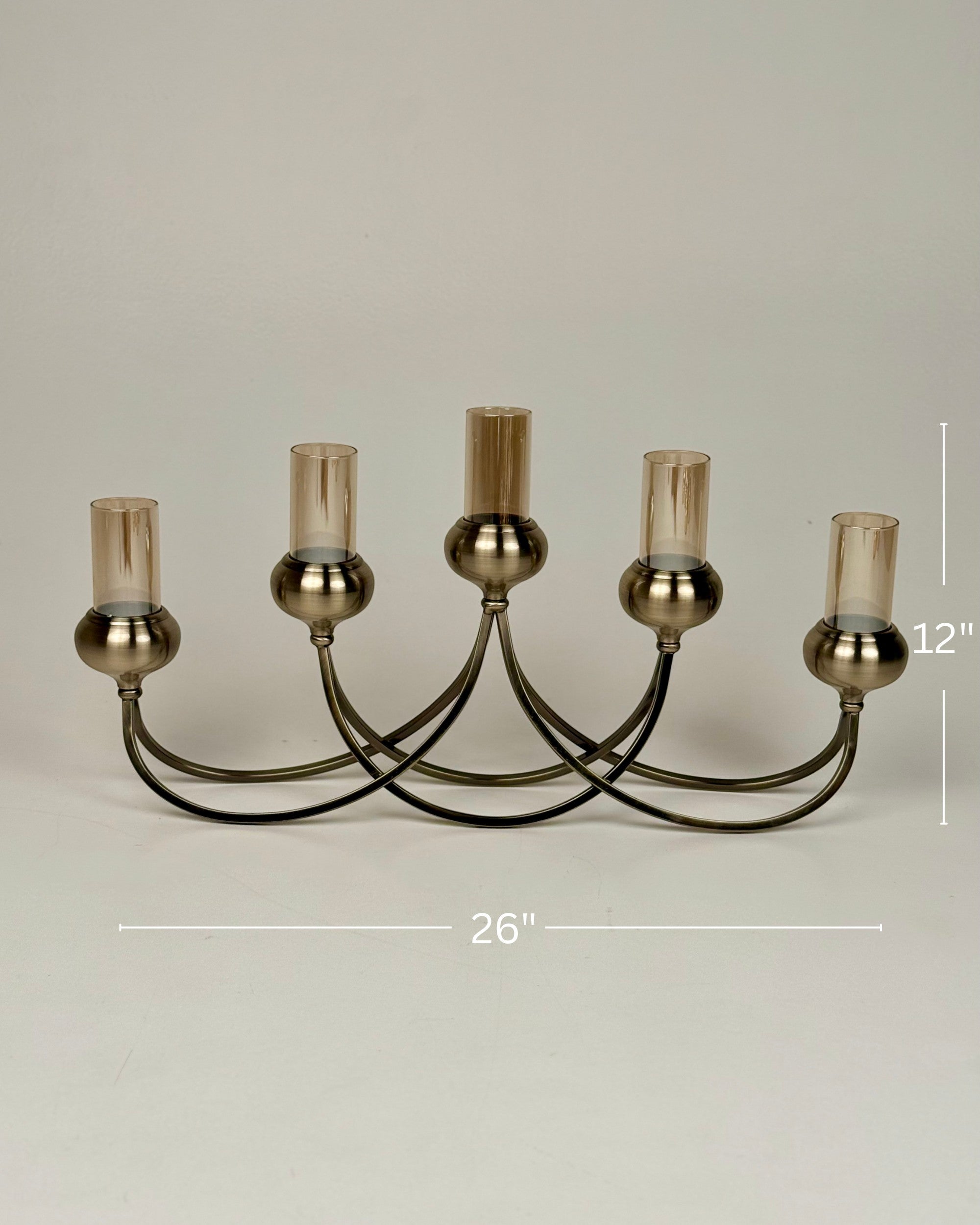 High Objects Aria Five-Arm Candle Stand with tinted glass holders and antique brass finish. 26" W x 12" H.