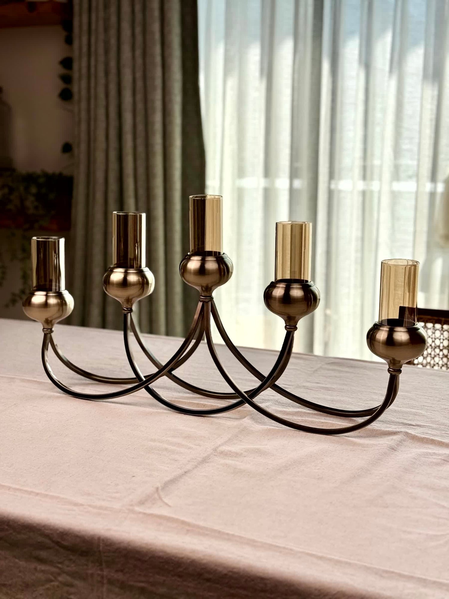 High Objects Aria Five-Arm Candle Stand in antique brass with glass holders, elegant centerpiece for dining tables.