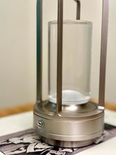 High Objects Aria Frame Table Lamp with brushed metal base, clear glass shade, and frosted diffuser. Modern lantern design.