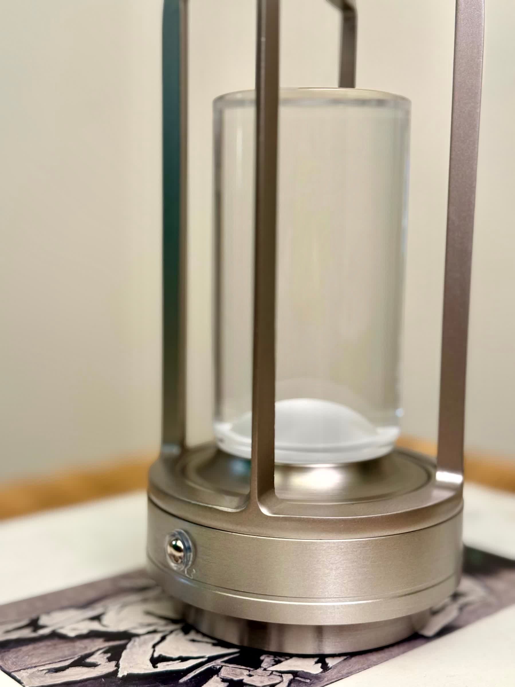 High Objects Aria Frame Table Lamp with brushed metal base, clear glass shade, and frosted diffuser. Modern lantern design.