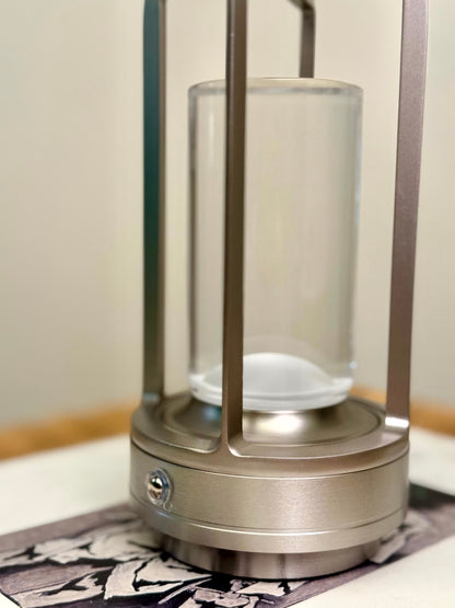 High Objects Aria Frame Table Lamp with brushed metal base, clear glass shade, and frosted diffuser. Modern lantern design.