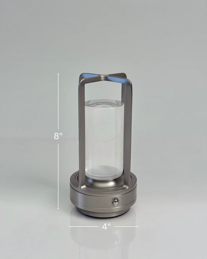 High Objects Aria Frame Table Lamp with brushed metal base, clear glass shade, and frosted diffuser. Modern lantern design.