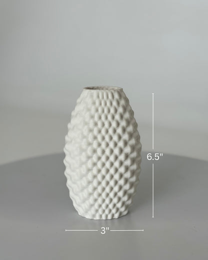 High Objects Arisca Vase, white ceramic with a textured, wave-like pattern. 6.5" H x 3" W.