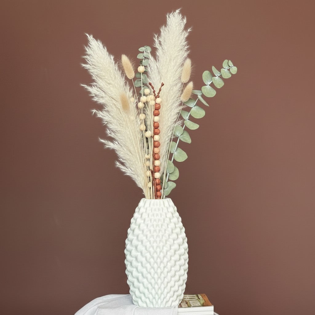 High Objects Arisca Vase, white ceramic with textured wave pattern, holding dried pampas grass and eucalyptus.