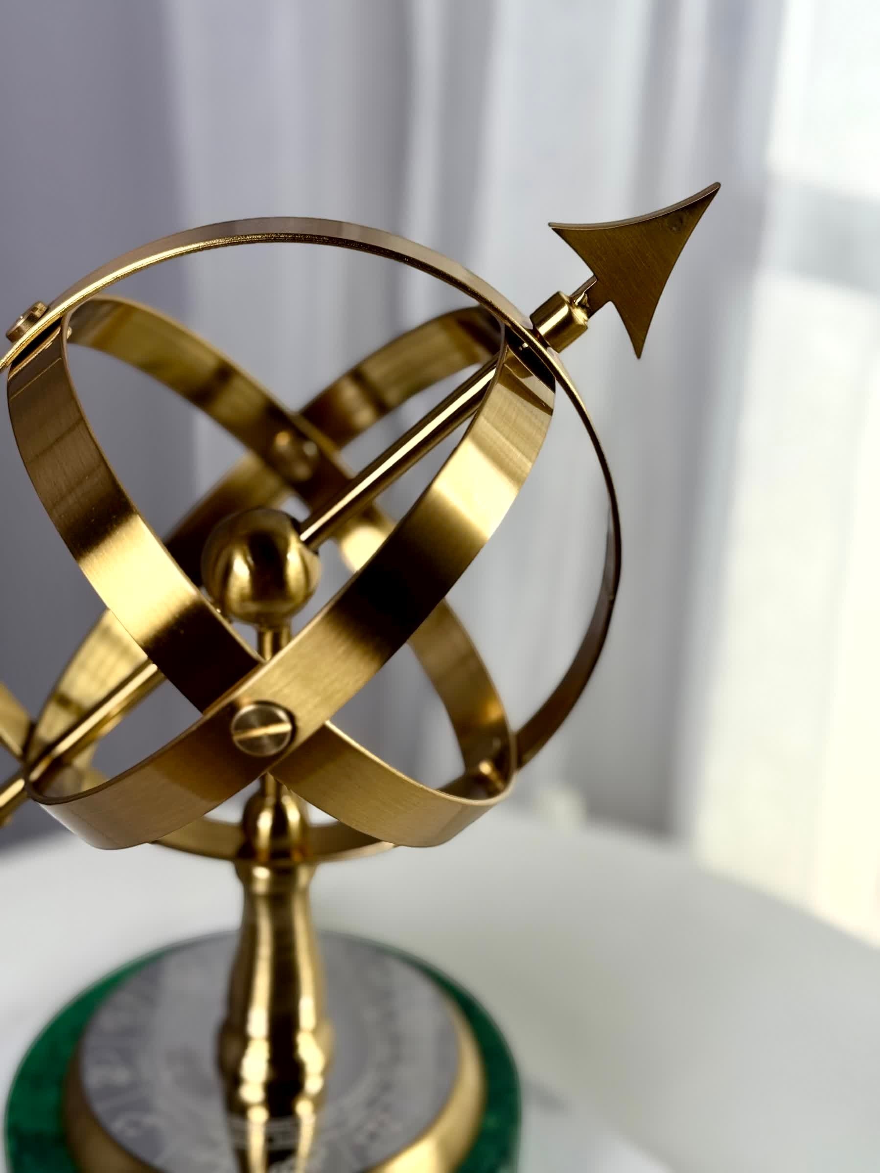 High Objects Armillary Globe Artefact with brass finish globe and arrow on green marble base.
