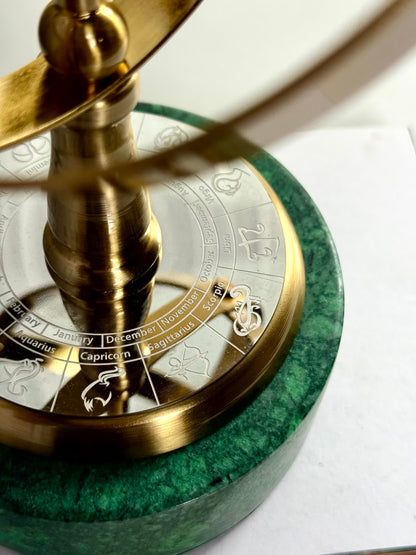 High Objects Armillary Globe Artefact with brass finish, zodiac symbols, and green marble base.