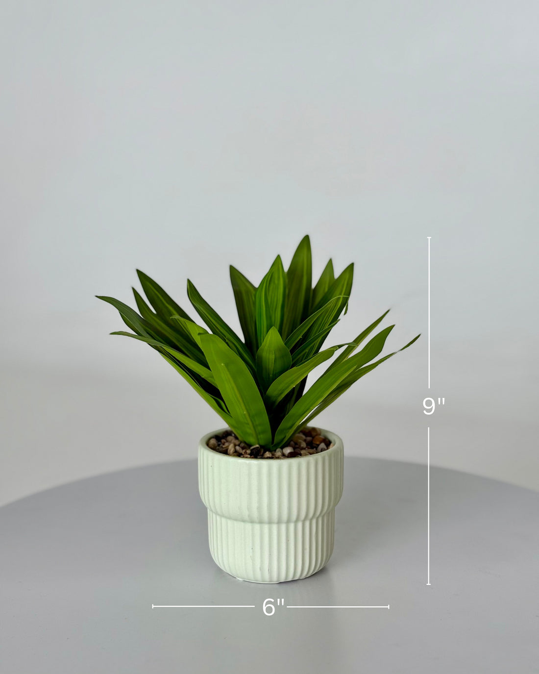 High Objects Artificial Dracaena Lemon Lime Plant with striped green leaves in a white ribbed ceramic pot with pebbles.