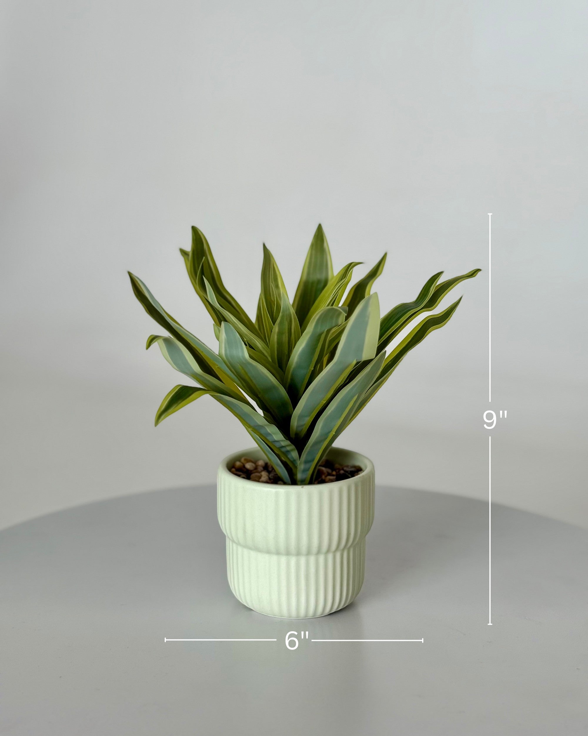 High Objects Artificial Dracaena Lemon Lime Plant with striped green and yellow leaves in a light green ribbed ceramic pot.