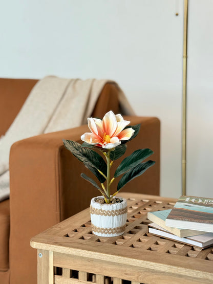 High Objects artificial lily plant with white and orange bloom in a striped ceramic pot with pebbles.