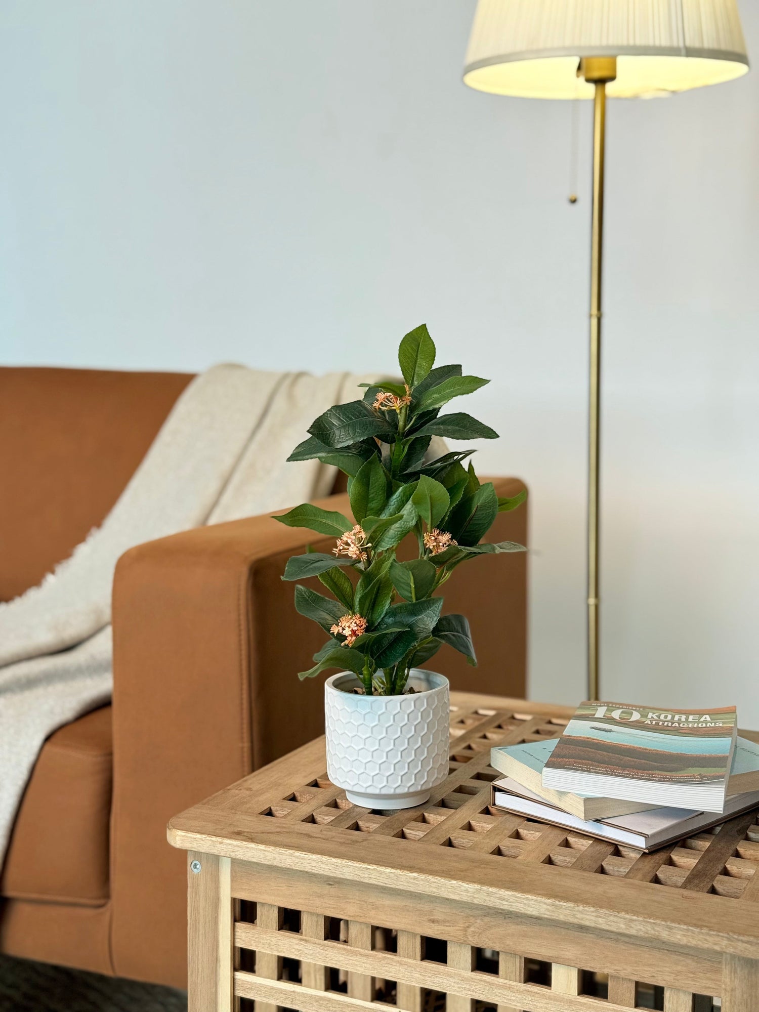High Objects Artificial Orange Bloom Camellia Plant with green leaves in a white honeycomb pot.