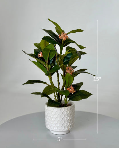 High Objects Artificial Orange Bloom Camellia Plant with green leaves in a white honeycomb pot.