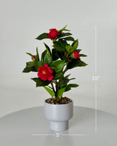 High Objects Artificial Scarlet Camellia Plant with vibrant red blooms and lush green leaves in a white pot.