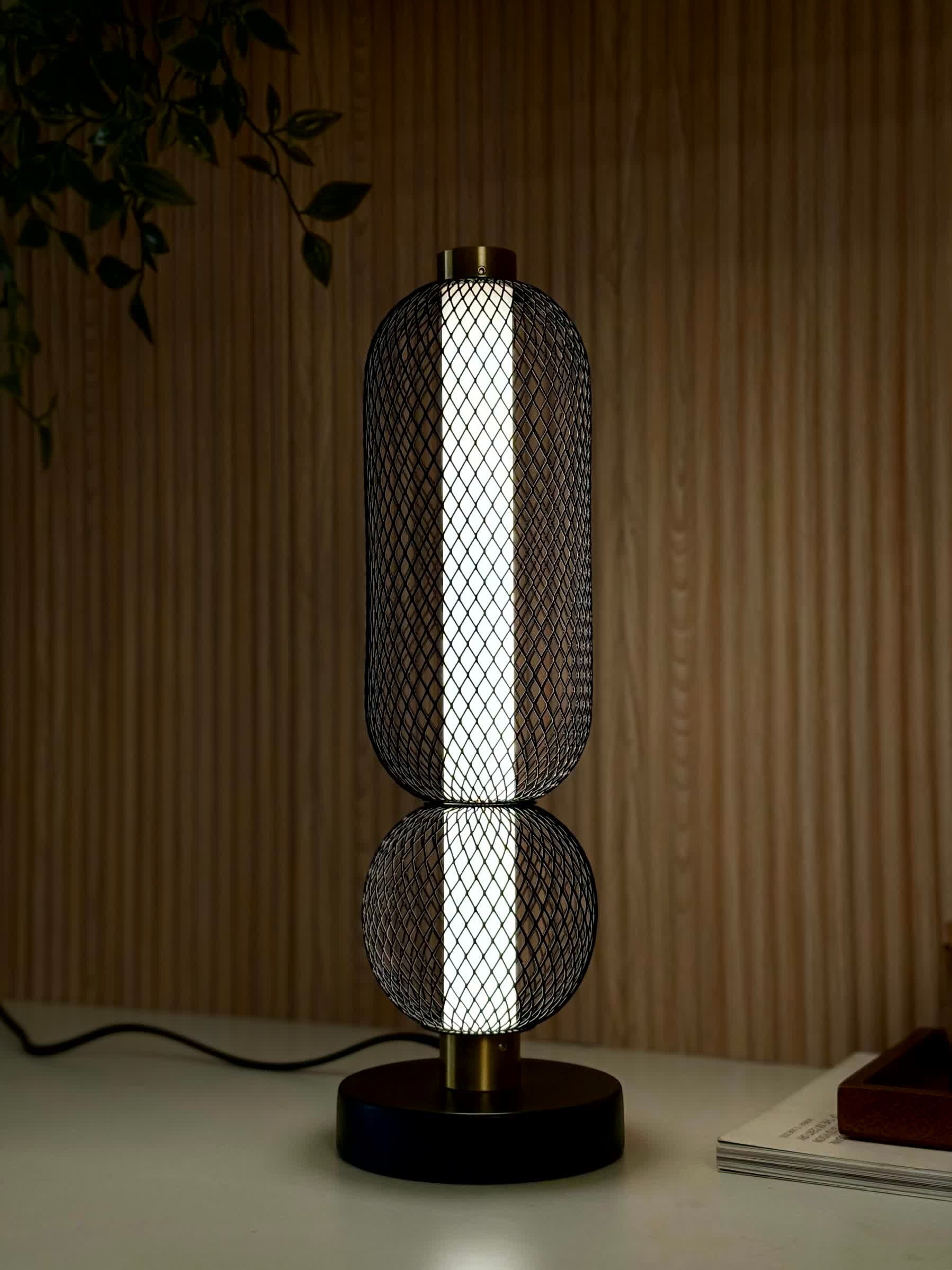High Objects Atlas Mesh Column Table Lamp with stacked sphere and cylinder shades, brushed gold accents, and black base.