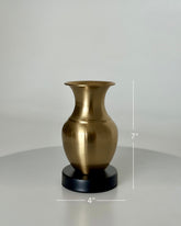 High Objects Aurelia Vase, brushed gold metallic finish, rounded body, flared neck, on a black base. 7" H x 4" W.