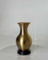 High Objects Aurelia Vase, brushed gold metallic finish, rounded body, flared neck, on black base. 9" H x 4.5" W.