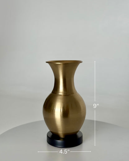 High Objects Aurelia Vase, brushed gold metallic finish, rounded body, flared neck, on black base. 9" H x 4.5" W.