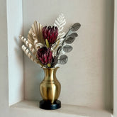 High Objects Aurelia Vase: brushed gold metallic vase with black base, holding dried bunny tail grass.