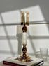 High Objects Aurora Column Candle Stand Set with amber glass shade, gold metal accents, and white marble-effect column.
