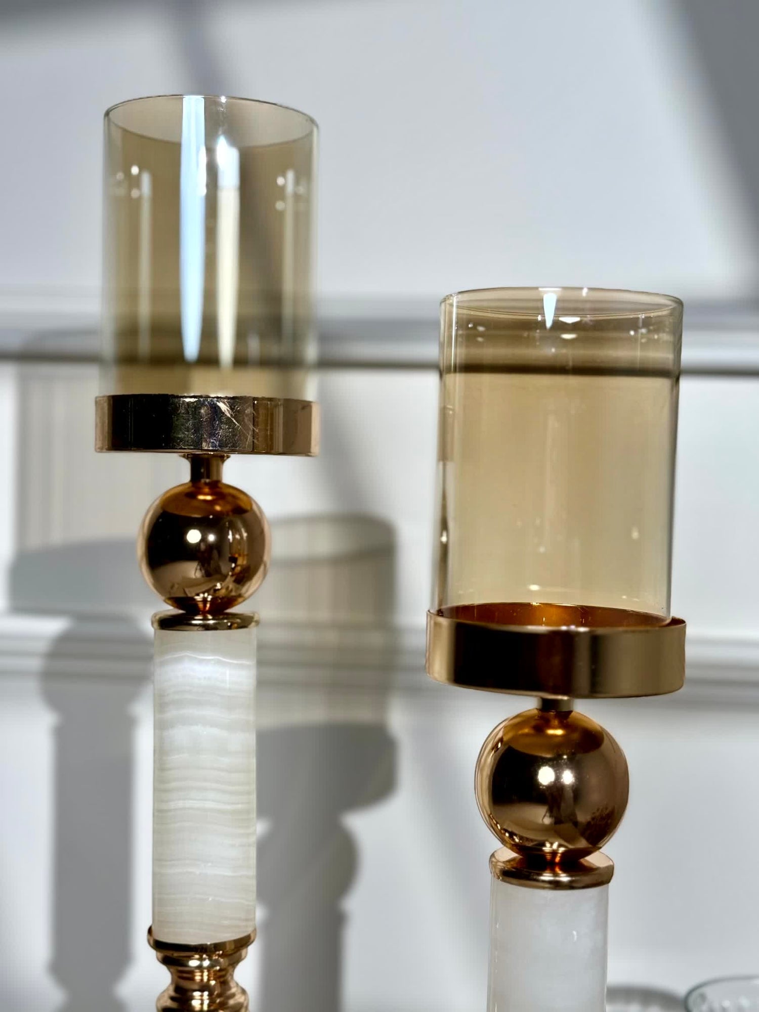 High Objects Aurora Column Candle Stand Set with amber glass shade, gold sphere and white stone column.
