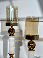 High Objects Aurora Column Candle Stand Set with amber glass shade, gold sphere and white stone column.