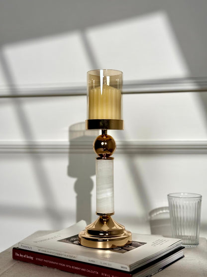 High Objects Aurora Column Candle Stand Set with gold accents, white marble column, and amber glass holder with candle.