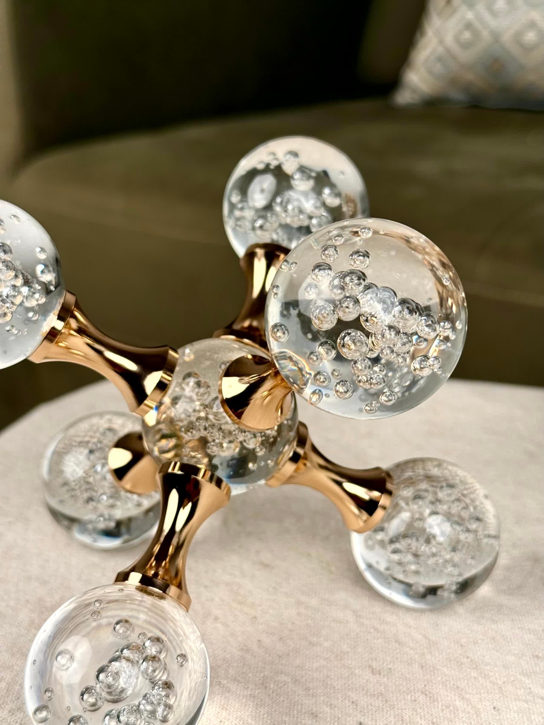 High Objects Aurora Orb Sculpture Artefact with clear glass spheres containing bubbles and rose gold metallic rods.