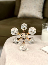 High Objects Aurora Orb Sculpture Artefact with clear glass spheres filled with bubbles, connected by gold rods.