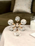 High Objects Aurora Orb Sculpture Artefact with clear glass spheres filled with bubbles, connected by gold rods.