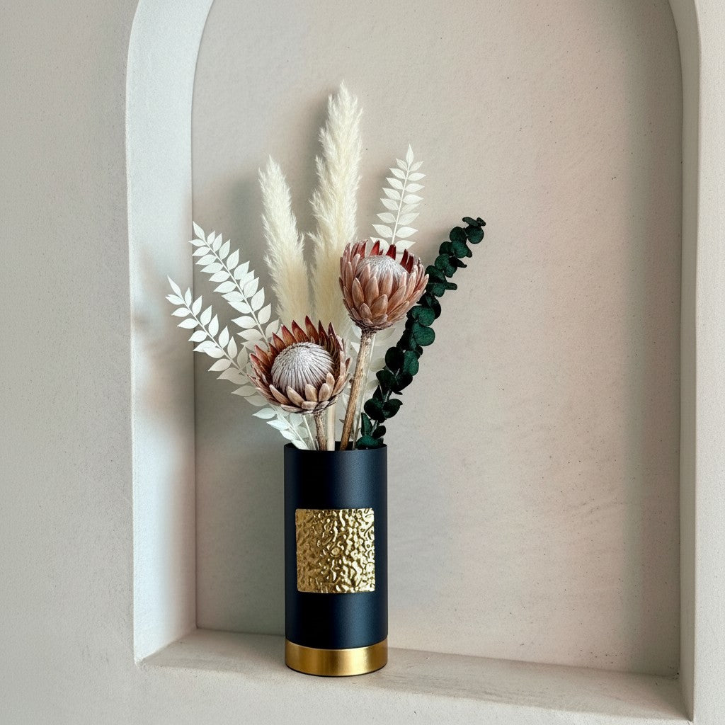 High Objects Aurum Noir matte black cylindrical vase with textured gold band and base, holding dried floral arrangement.