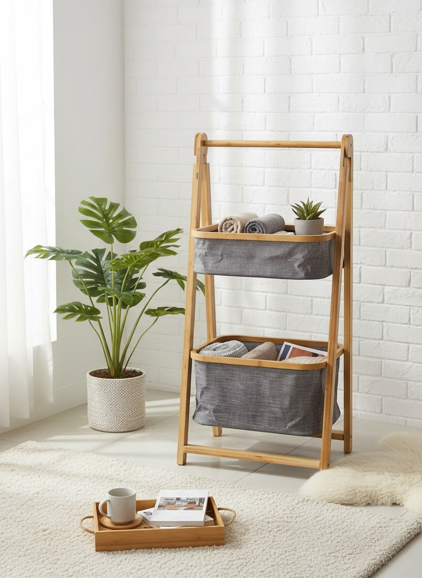 High Objects natural bamboo frame storage organizer with two grey fabric baskets holding towels and magazines.