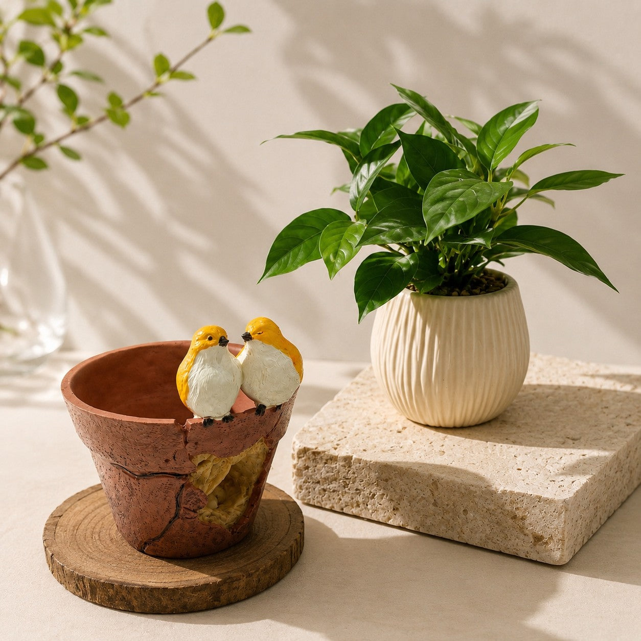 High Objects decorative terracotta-style planter with two yellow birds perched on the rim next to a potted green plant