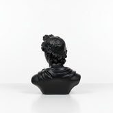 High Objects black matte bust of a classical figure with curly hair and draped clothing, a decorative showpiece.