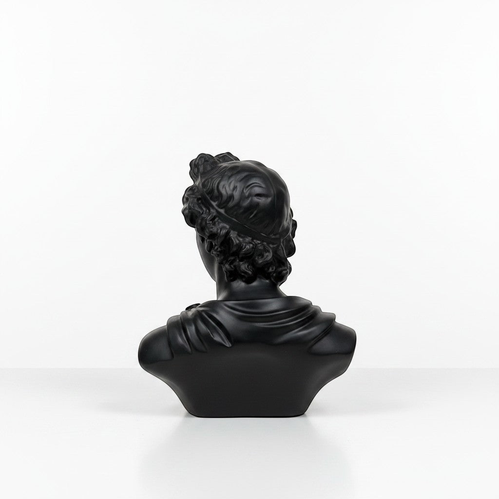 High Objects black matte bust of a classical figure with curly hair and draped clothing, a decorative showpiece.
