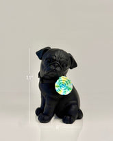 High Objects matte black pug sculpture with a colorful swirl lollipop accent. Modern home decor.