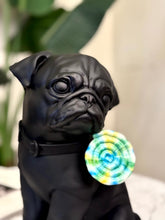 High Objects matte black pug showpiece holding a colorful tie-dye lollipop. Modern home decor.
