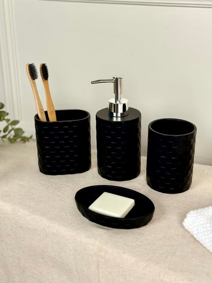 High Objects black woven bathroom accessory set with soap dish, toothbrush holder, soap dispenser, and cup.