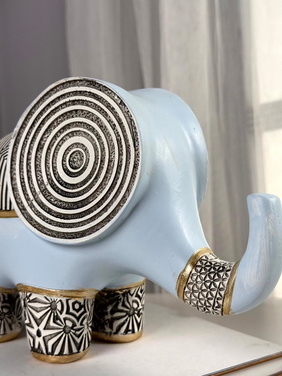 High Objects light blue polyresin elephant figurine with black and white geometric patterns and gold accents.