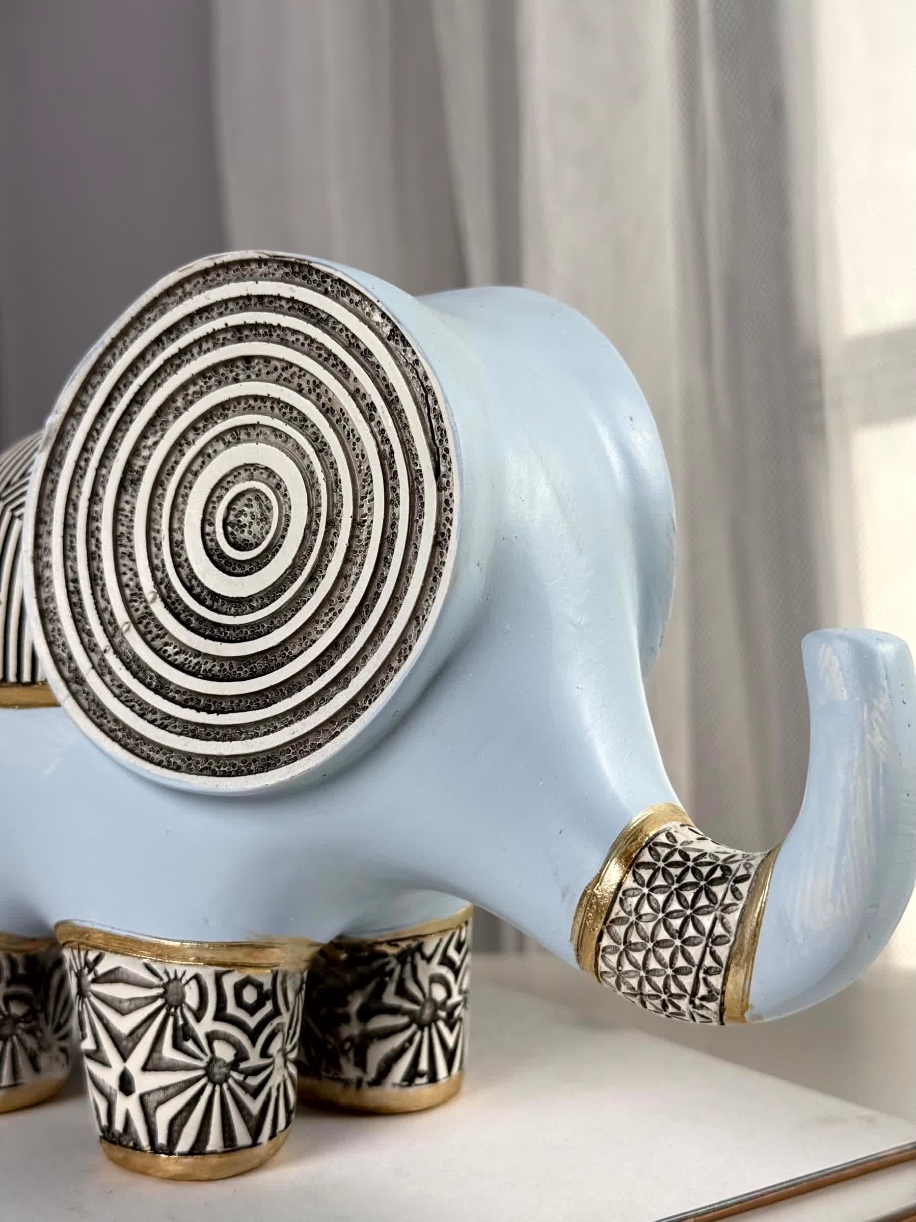 High Objects light blue polyresin elephant figurine with black and white geometric patterns and gold accents.