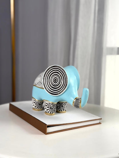 High Objects small blue polyresin elephant figurine with black and gold geometric patterns and concentric circles on its back.