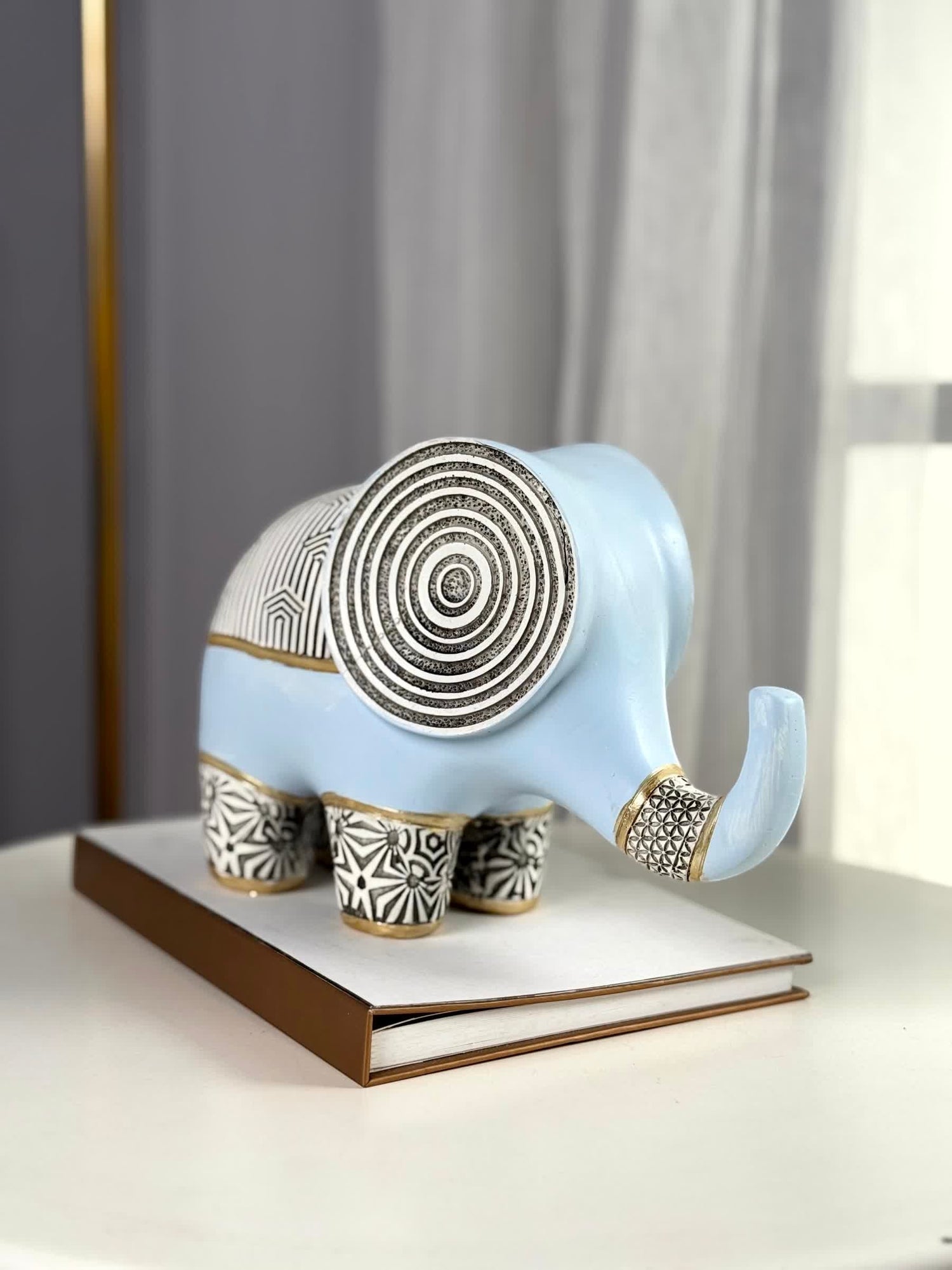 High Objects light blue polyresin elephant figurine with black and gold geometric patterns, concentric ear details.