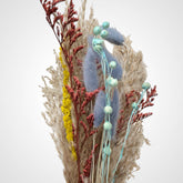 High Objects Botanical Coastal Prairie dried flower arrangement with pampas grass, blue bunny tails, red foliage, and yellow accents.