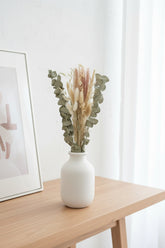 High Objects Botanical Eucalyptus Harvest dried flower arrangement with eucalyptus, pampas grass, bunny tails, and grain stems in a white vase.