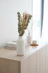 High Objects Botanical Eucalyptus Harvest dried flower arrangement with eucalyptus, pampas grass, bunny tails, and grain stems in a white vase.