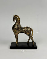High Objects bronze and black zebra showpiece with striped pattern on a black base.