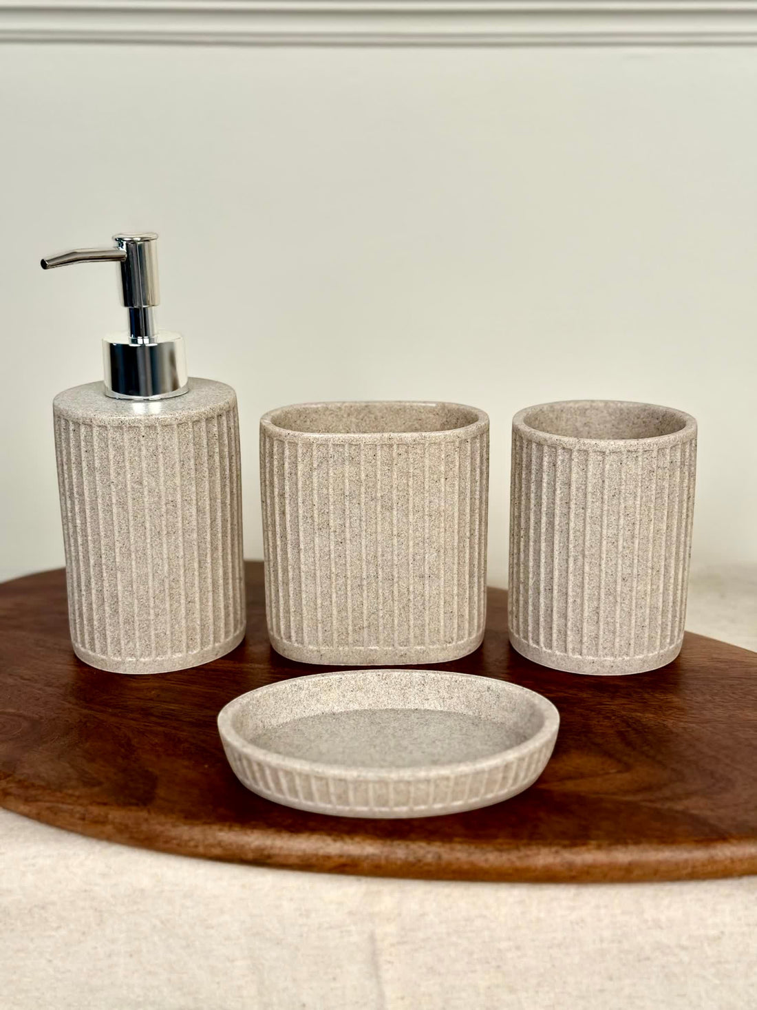 High Objects Calmridge 4-piece bathroom accessory set in beige with ribbed texture, includes soap dispenser, toothbrush holder, cup, and soap dish.