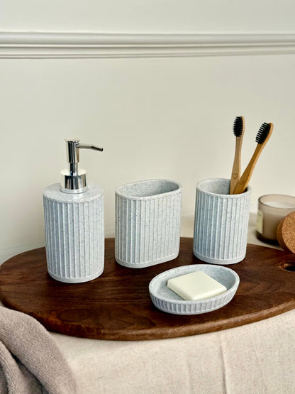 High Objects Calmridge Bathroom Accessory Set: ribbed lotion dispenser, oval holder, toothbrush cup, and soap dish in speckled light blue.